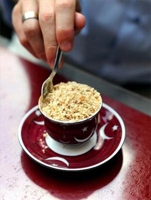 A cup of Turkish coffee with almonds