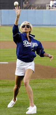 A wendyballer's wife trying to throw a baseball