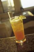 Fruit Juice and Vodka Cocktail with Lime and Straw