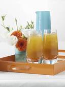 Apricot juice and small posy of flowers on tray